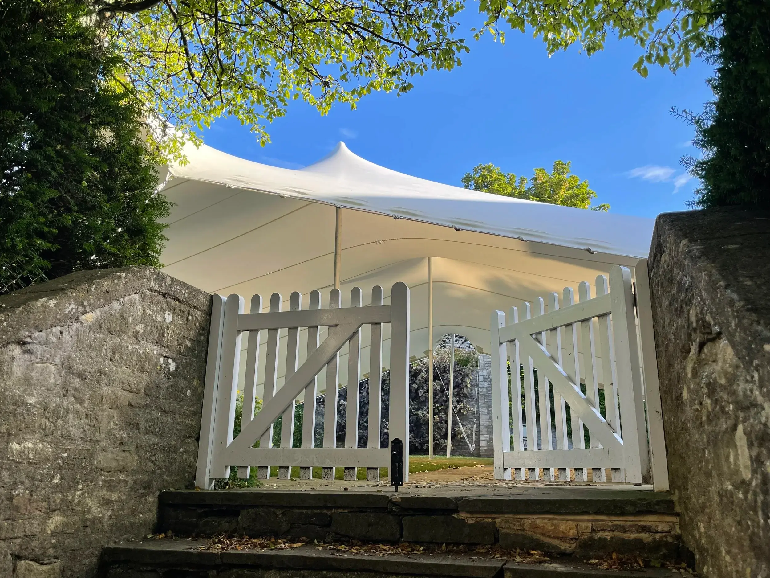 White stretch tent behind a garden gate in Oxfordshire