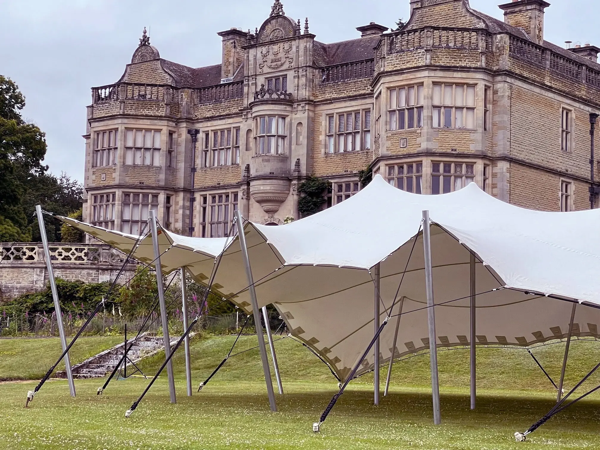 White stretch tent on the lawn of a Jacobean manor house